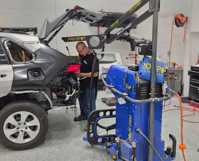Technician-doing-auto-body-repair-aluminum-welding-menu