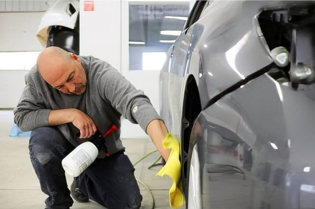 Auto Body Technician working on car at Heritage Collision Auto-Body-Technician-working-on-car-at-Heritage-Collision.